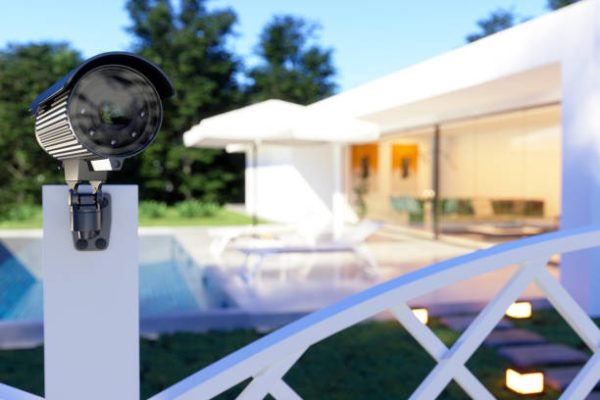 Exterior Of A Villa With Security Camera At The Entrance Of The Garden.